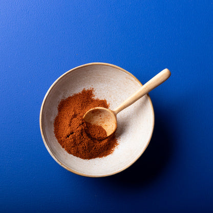 Organic Cayenne Pepper Powder from Wild Elephant, a vibrant red spice in a clear jar for herbs and spices collection.