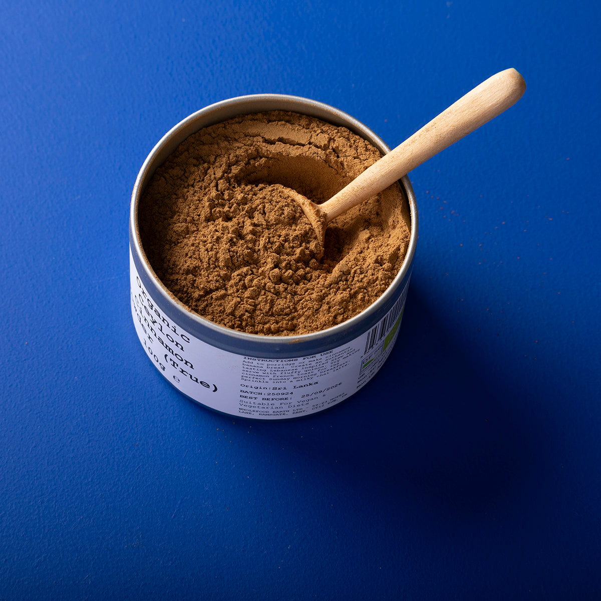 Organic Ceylon cinnamon powder from Wild Elephant in a 100g package, showcasing fine, light brown spice in a clear container.