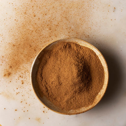 Organic Ceylon cinnamon powder from Whole Food Earth, fine ground herb and spice with warm brown color and aromatic scent.