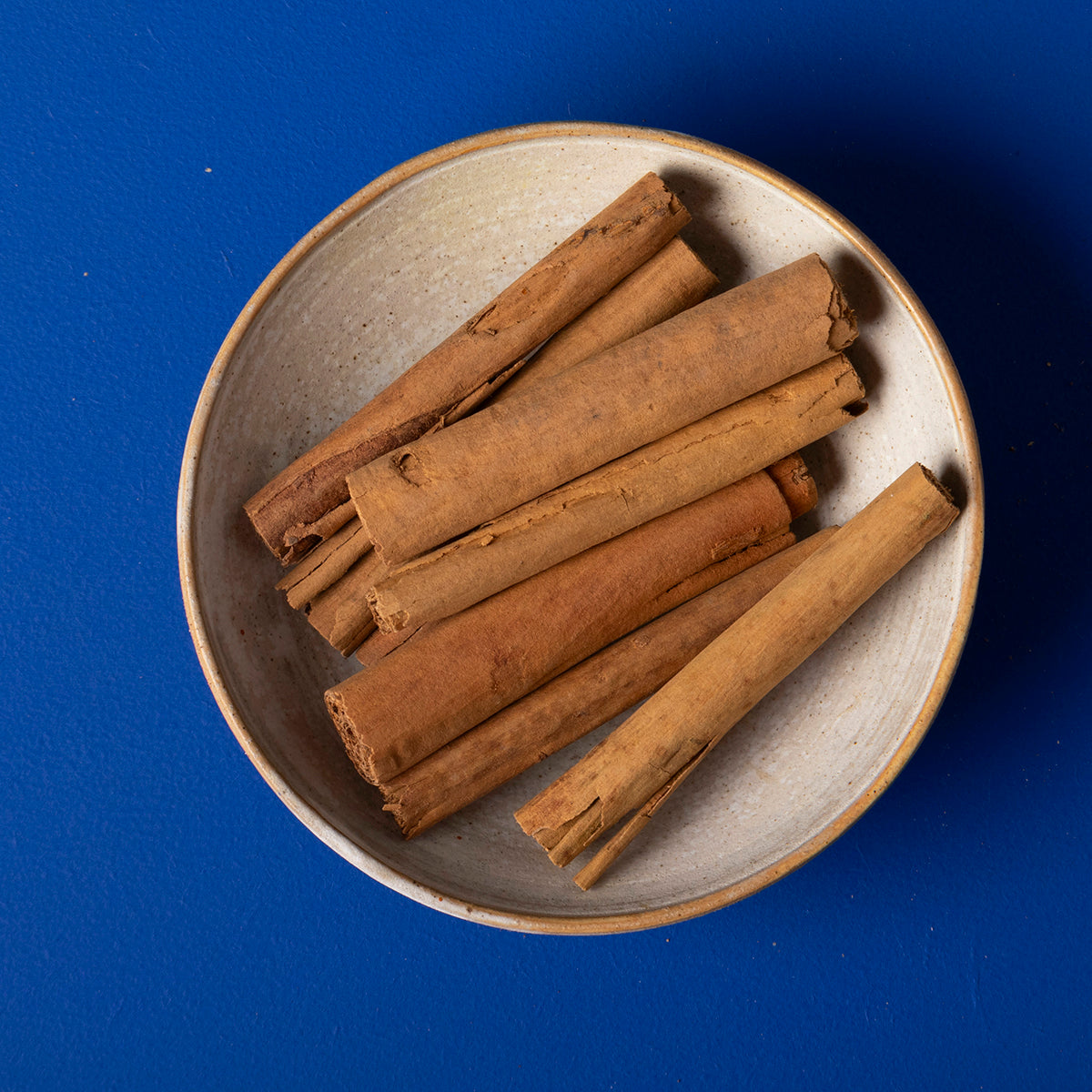 Organic Ceylon cinnamon sticks from Wild Elephant, 80g, in a clear jar, showcasing the aromatic cinnamon sticks on a wooden surface.