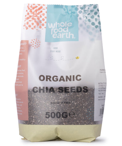 Organic chia seeds in a clear container, showing small black and white seeds from Whole Food Earth on a white background.