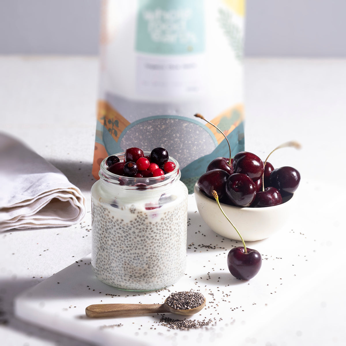 Close-up of organic chia seeds from Whole Food Earth in a glass jar, showing tiny, oval-shaped seeds with a matte finish.