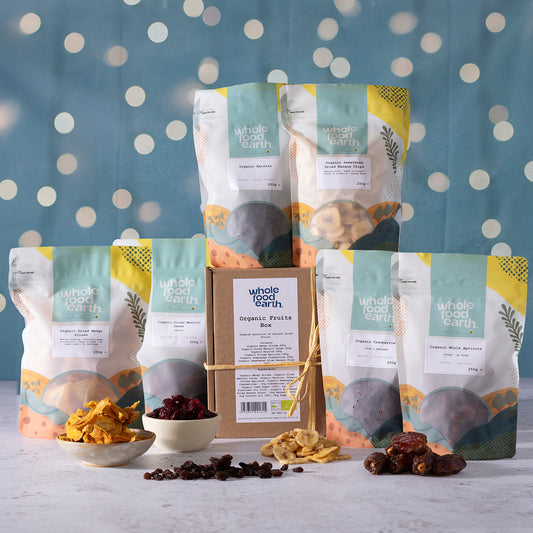 Organic Christmas Fruits Box featuring a variety of nuts and seeds from Whole Food Earth, displayed in a festive arrangement.