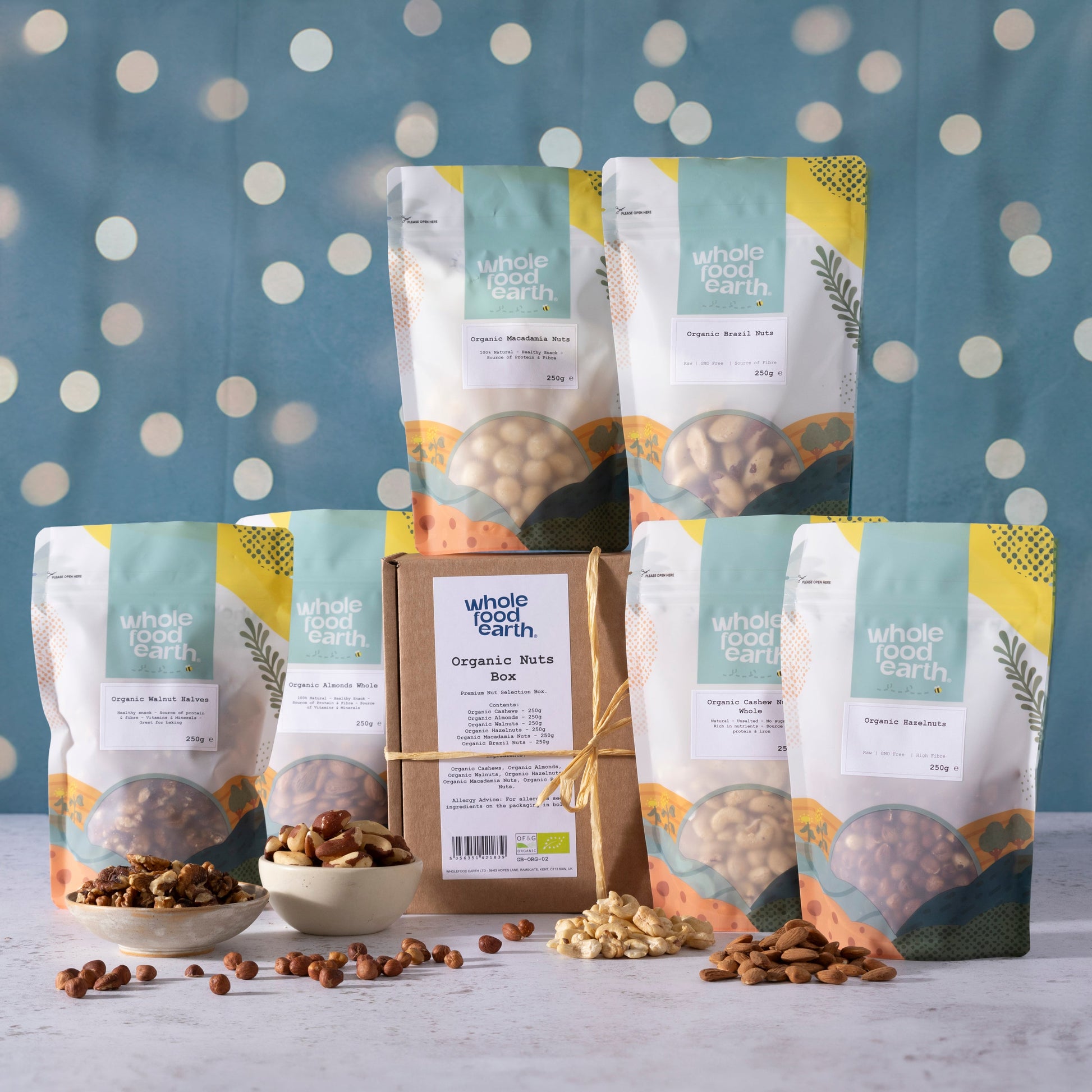 Organic Christmas nuts box by Whole Food Earth featuring a variety of mixed nuts and seeds in festive packaging.
