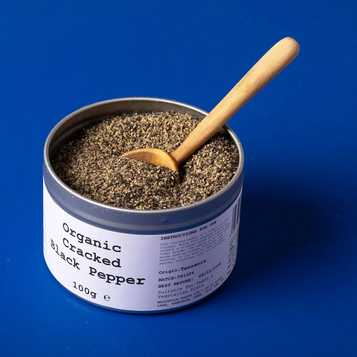 Organic cracked black pepper from Wild Elephant, Whole Food Earth herb and spice, showing freshly ground black pepper in a jar