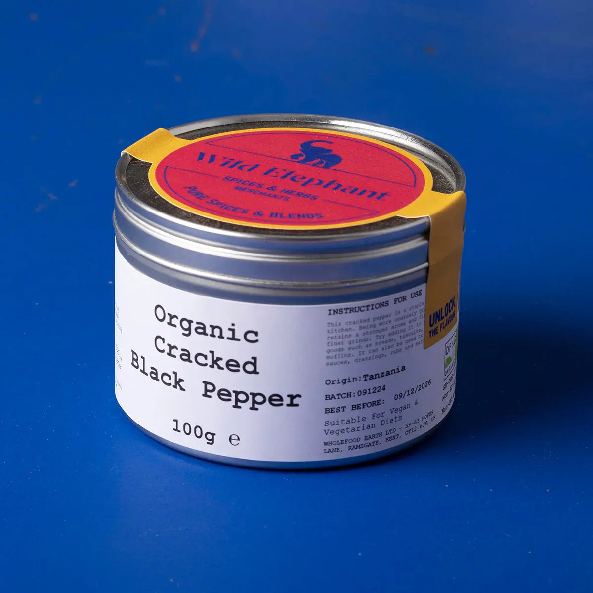 Organic cracked black pepper from Wild Elephant, part of Whole Food Earth herbs and spices collection, shown in a clear glass jar.