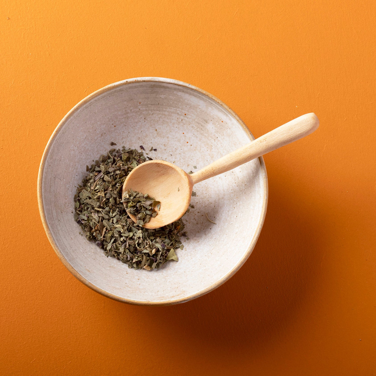 Organic dried basil herbs from Whole Food Earth, close-up of green, leafy basil leaves in a 75g package.