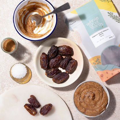 Organic dried Medjool dates from Whole Food Earth, showing a close-up of glossy, plump dates in a natural setting.
