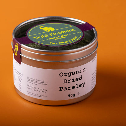 Organic dried parsley from Wild Elephant, 50g, in a jar, showcasing fresh green herbs for cooking or garnishing.