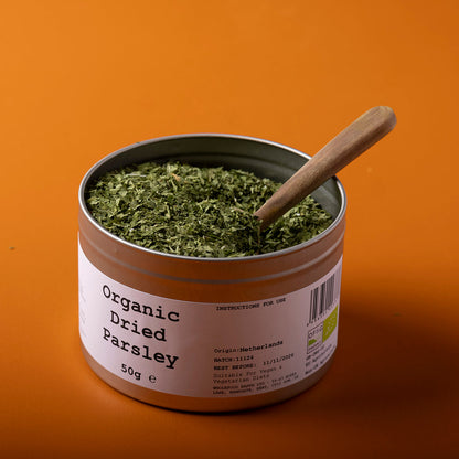 Organic dried parsley from Whole Food Earth, wild-harvested herb in a 50g package, shown in a close-up image.