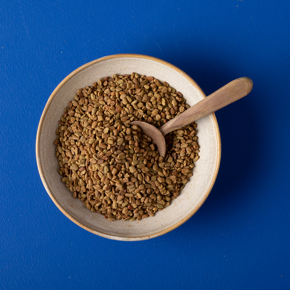 Organic Fenugreek Seeds from Whole Food Earth, wild-harvested herbs and spices, showing fresh, golden seeds in a clear container.