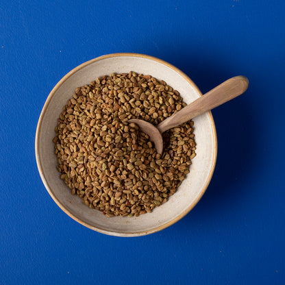 Organic Fenugreek Seeds from Whole Food Earth, wild-harvested herbs and spices, showing fresh, golden seeds in a clear container.