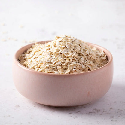 A bowl of organic gluten-free porridge oats from Whole Food Earth, showing the wholesome, raw oat grains in a natural setting.