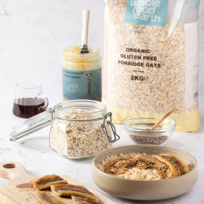 Whole Food Earth organic gluten-free porridge oats in a bowl, surrounded by fresh ingredients for a healthy breakfast.