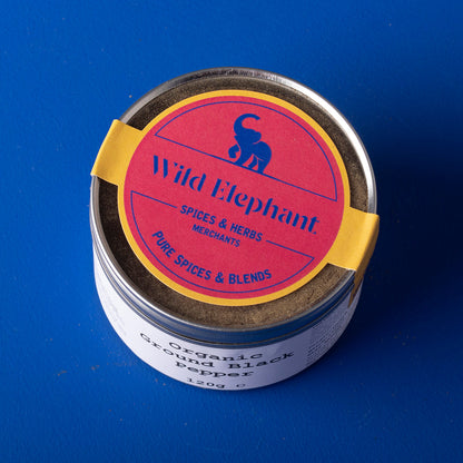 Organic ground black pepper from Wild Elephant, Whole Food Earth herbs and spices, showing fresh, coarsely ground black pepper in a jar.
