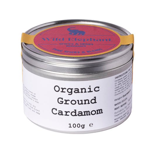 Organic ground cardamom from Wild Elephant in a 100g package, shown in a clear spice jar with a label on a wooden surface.