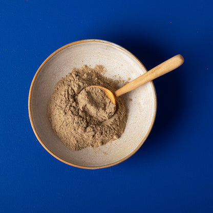 Organic ground cardamom from Wild Elephant, 100g, showing fresh, finely ground green spice in a clear jar.