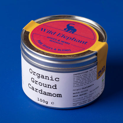 Organic ground cardamom in a clear jar from Whole Food Earth, showcasing vibrant green spice for herbs and spices.