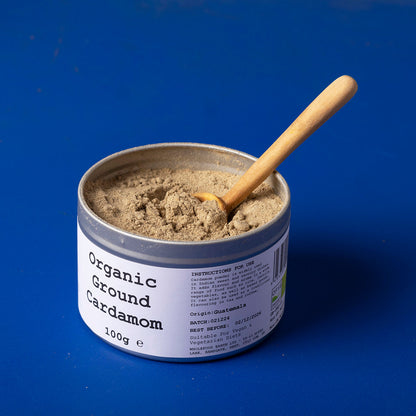 Organic ground cardamom spice from Whole Food Earth in a 100g package, featuring fresh, aromatic ground cardamom seeds.