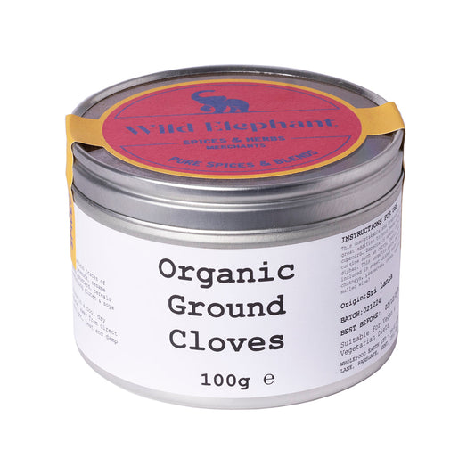 Organic ground cloves from Wild Elephant by ArtisanBox, showing a close-up of the aromatic, dark brown spice in a jar.