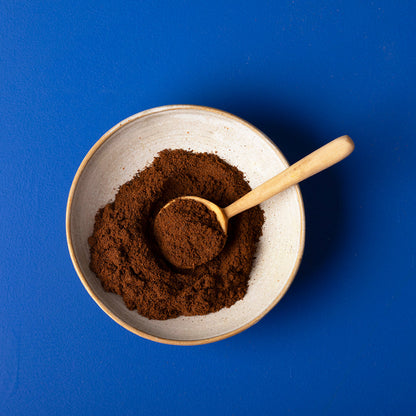 Organic ground cloves from Wild Elephant, 100g, in a glass jar, showing dark brown spice with a textured surface.