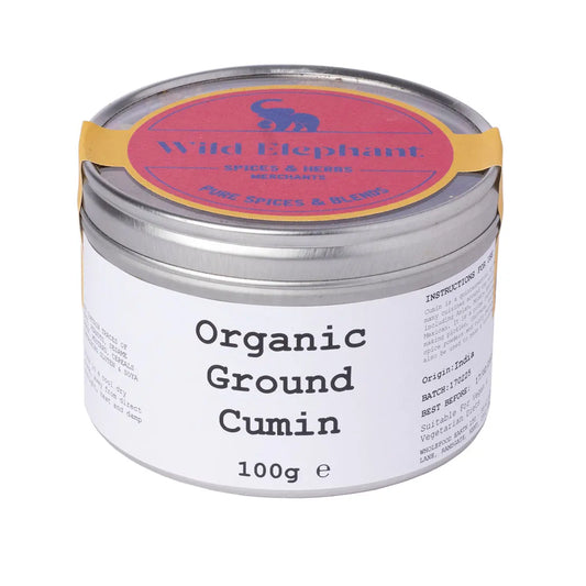 Organic ground cumin spice from Wild Elephant, 100g, showing the earthy brown powder in a glass jar with a label.