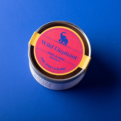 Organic ground nutmeg spice from Whole Food Earth, showing a jar of wild elephant brand ground nutmeg on a wooden surface.