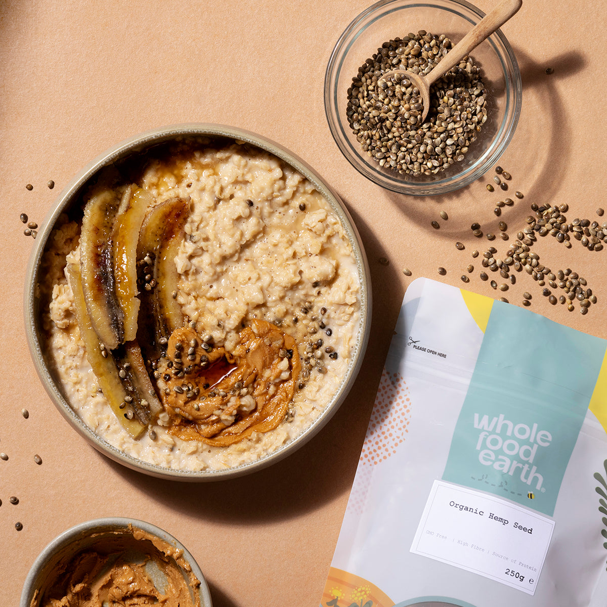 Organic hemp seeds from Whole Food Earth shown in a natural setting with a bowl of seeds and hemp plant leaves.