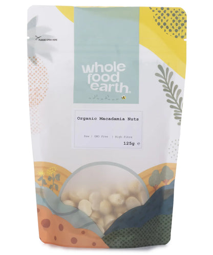 Organic Whole Food Earth macadamia nuts in a 125g package, showing fresh, whole nuts with textured shells and creamy interior.
