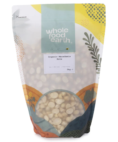 Two kilograms of Whole Food Earth organic macadamia nuts in a clear container, showcasing their creamy, whole nuts.