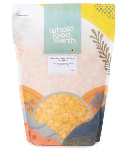Organic natural corn flakes cereal by Whole Food Earth in a 1kg package, showing crispy golden flakes in a bowl.