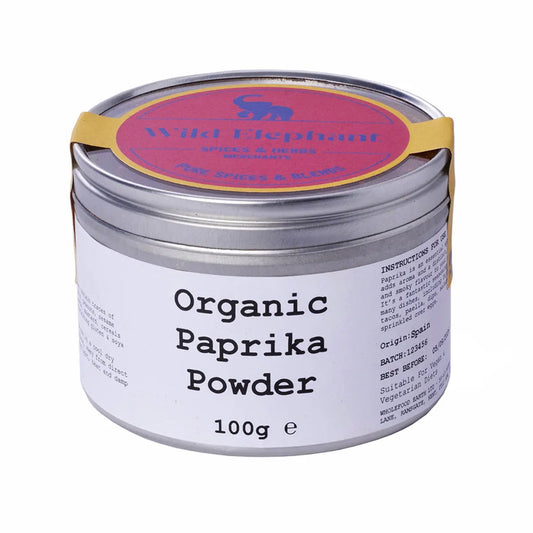 Organic paprika powder in a jar labeled Wild Elephant from ArtisanBox, showcasing vibrant red spice with a rustic background.