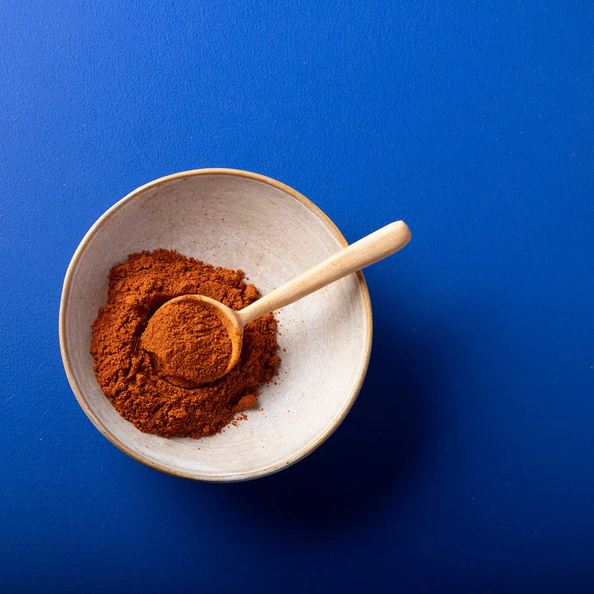 Organic paprika powder from Wild Elephant, a vibrant red spice in a clear jar, perfect for adding flavor to dishes.