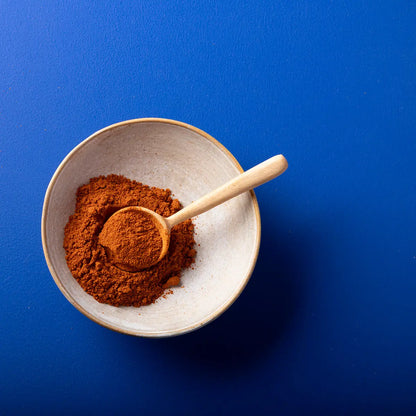 Organic paprika powder from Wild Elephant, a vibrant red spice in a clear jar, perfect for adding flavor to dishes.