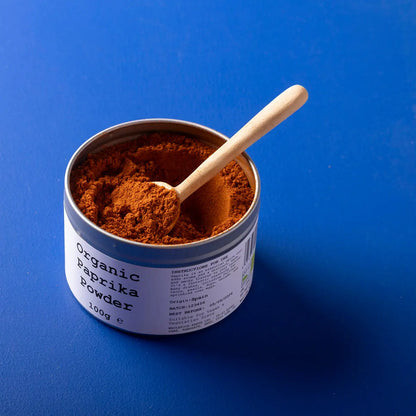 Organic paprika powder from Wild Elephant, a vibrant red herbs and spices blend in a clear jar, highlighting its rich color and texture.