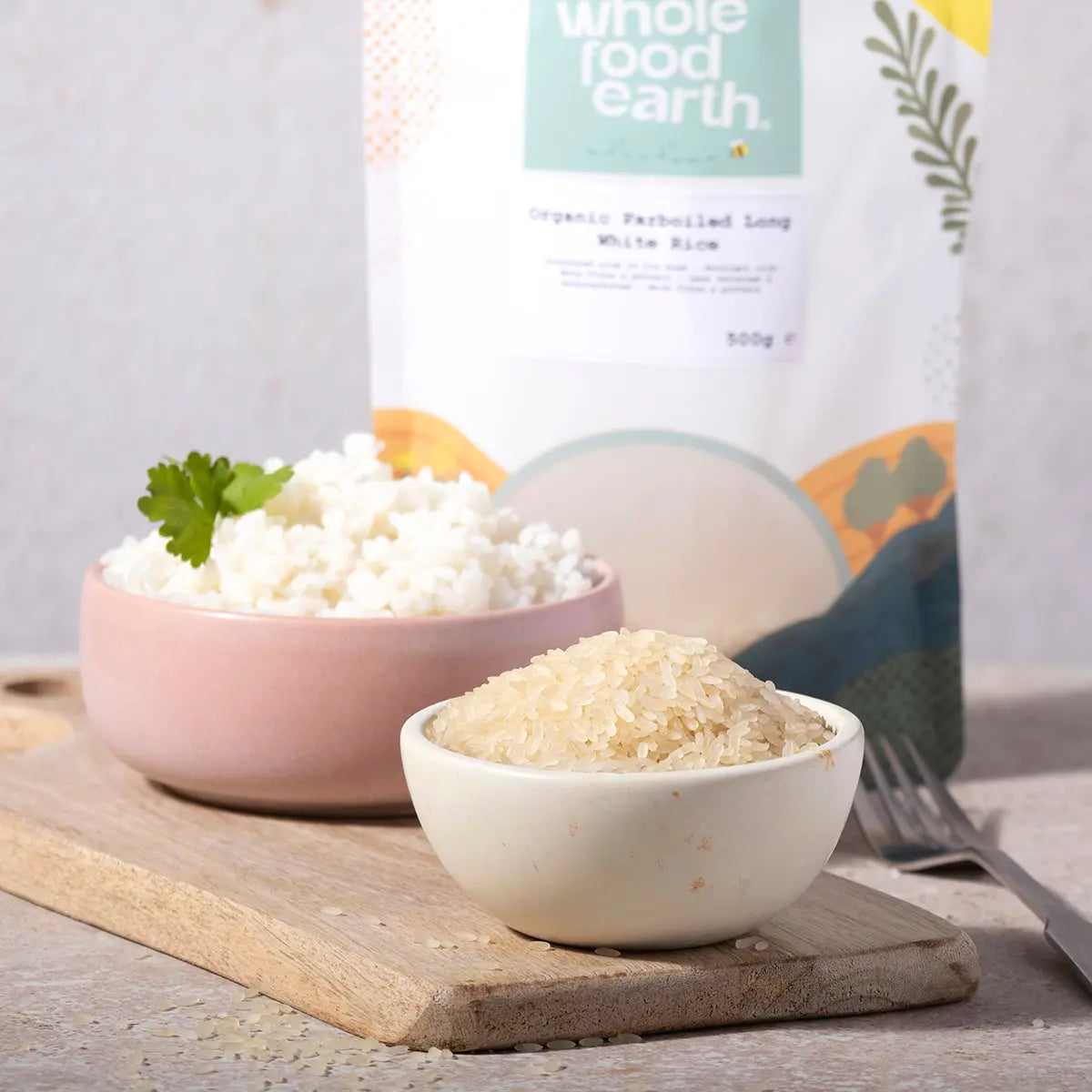 Organic Whole Food Earth parboiled long white rice grains in a bowl, showcasing the natural, fluffy cooked rice ready to serve.