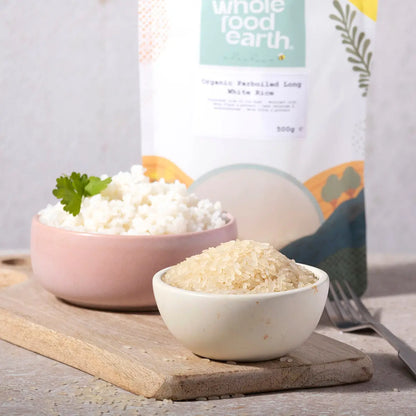 Organic Whole Food Earth parboiled long white rice grains in a bowl, showcasing the natural, fluffy cooked rice ready to serve.