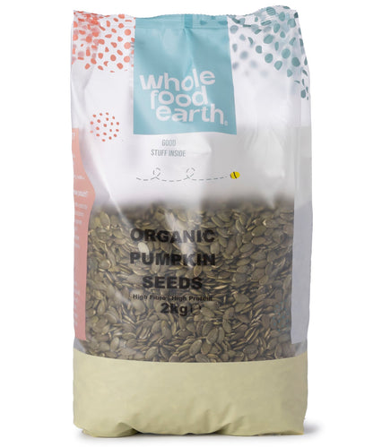 Organic Pumpkin Seeds from Whole Food Earth, raw and shelled, shown in a close-up of the greenish seeds in a clear container.