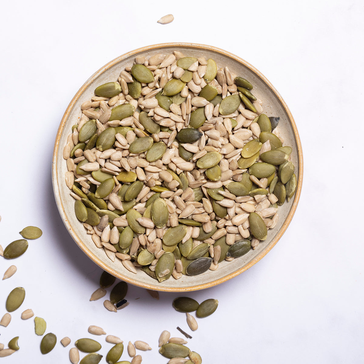 Organic pumpkin and sunflower seeds mix by Whole Food Earth featuring a blend of nutritious nuts and seeds in a natural setting.