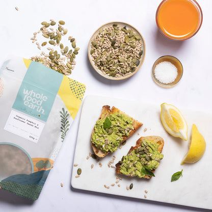 Mix of organic pumpkin and sunflower seeds from Whole Food Earth, displayed in a natural setting with seeds scattered.