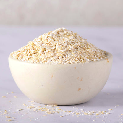 Organic quinoa flakes cereal from Whole Food Earth, showing a bowl of light, fluffy quinoa flakes on a wooden surface.