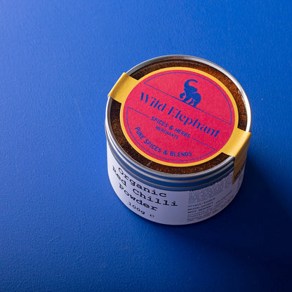 Organic red chili powder from Wild Elephant in a 100g package, showing vibrant red chili spice in a natural herbs and spices product.