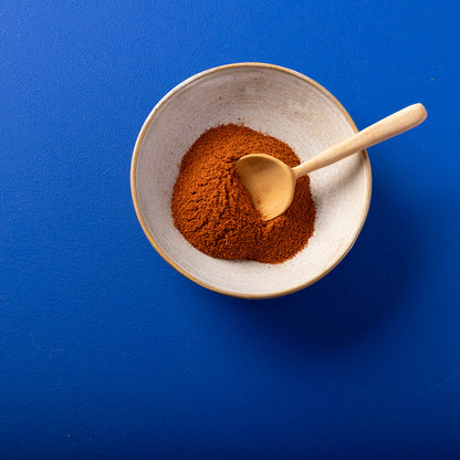 Organic red chili powder from Wild Elephant, 100g, in a clear jar showing bright red chili spice, ideal for flavorful cooking.