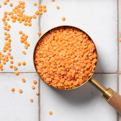 Organic red split lentils from Whole Food Earth, showing bright orange-red dried legumes in a bowl for beans and pulses.