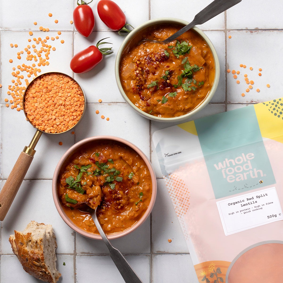 Organic red split lentils from Whole Food Earth, displayed in a bowl with a rustic kitchen background.