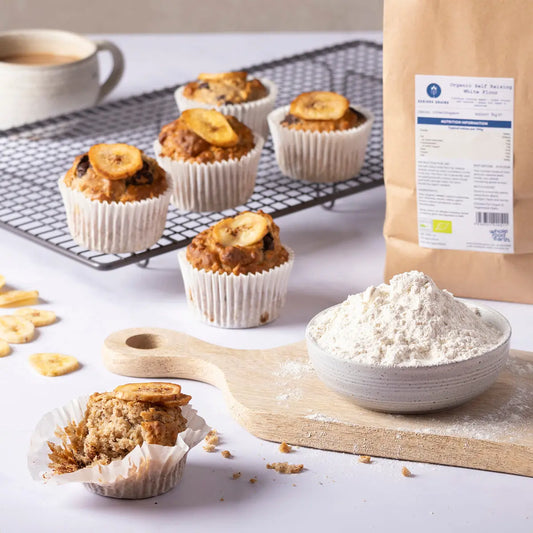 Organic Self Raising White Flour by ArtisanBox in a kitchen setting, showing a bag of white flour on a rustic wooden surface.