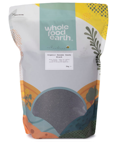 Black organic sesame seeds from Whole Food Earth, small roasted seeds in a clear container, ideal for cooking and baking.