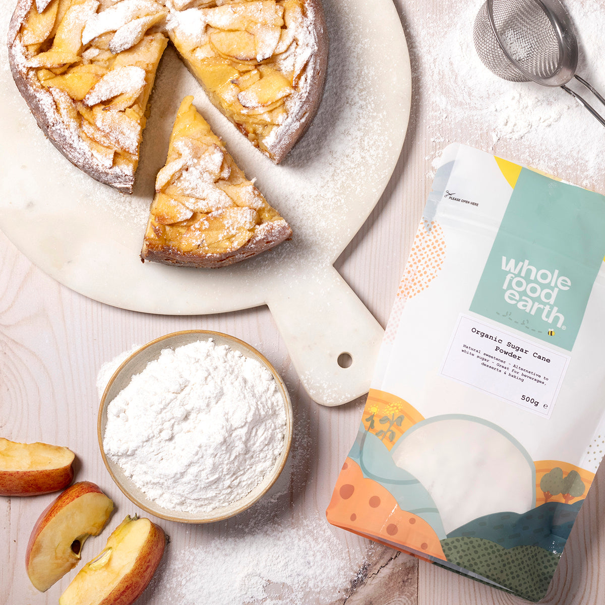 Organic sugar cane powder from Whole Food Earth, displayed in a kitchen setting with a scoop and jar for natural sweetening.