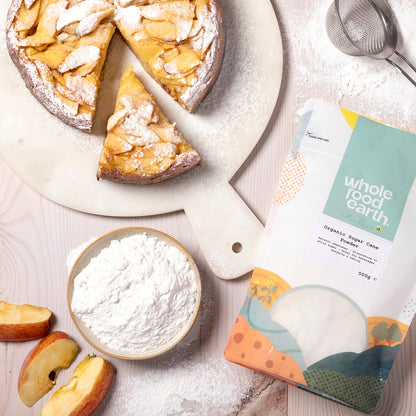 Organic sugar cane powder from Whole Food Earth, displayed in a kitchen setting with a scoop and jar for natural sweetening.