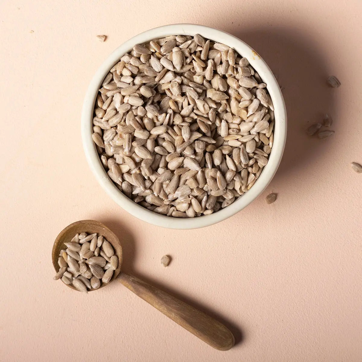 Whole Food Earth organic sunflower seeds, raw and unsalted, shown in a clear container on a white background.